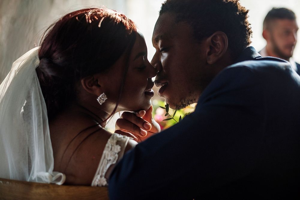 Newlywed African Descent Bride Kissing Groom Wedding Celebration