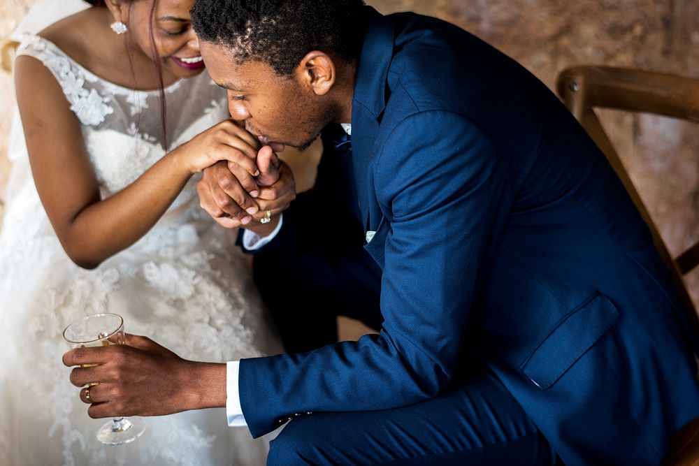 Newlywed African Descent Couple Kissing Hands
