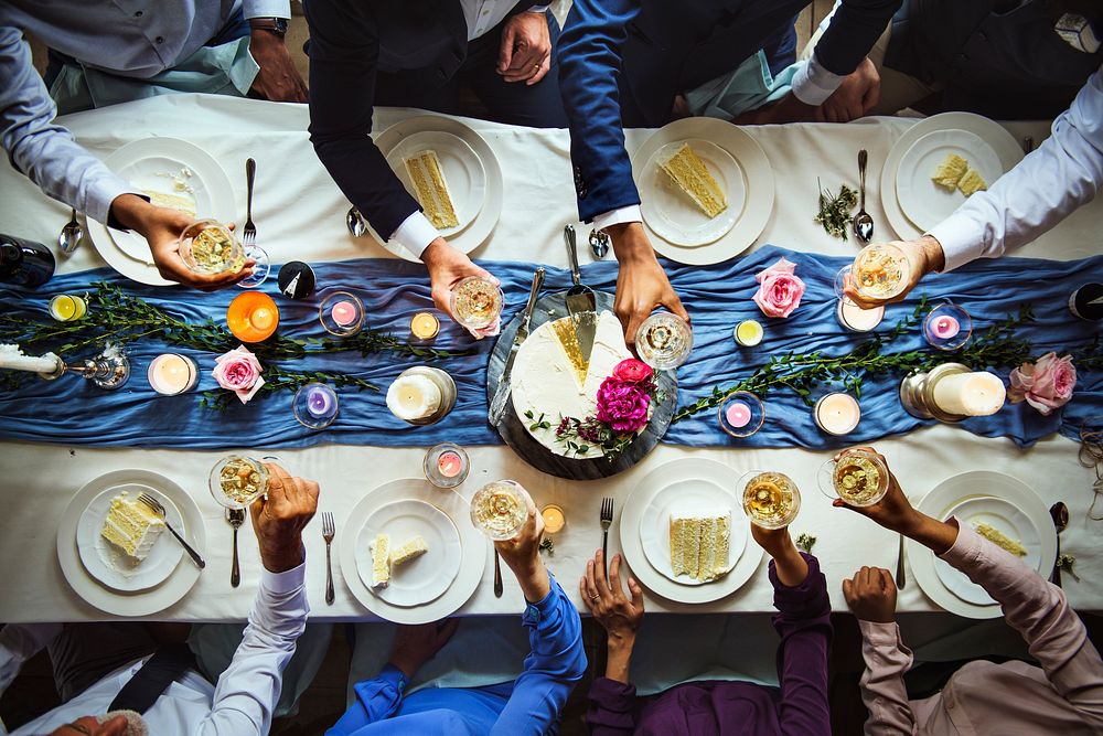 An aerial view of wedding guests doing a toast at the table