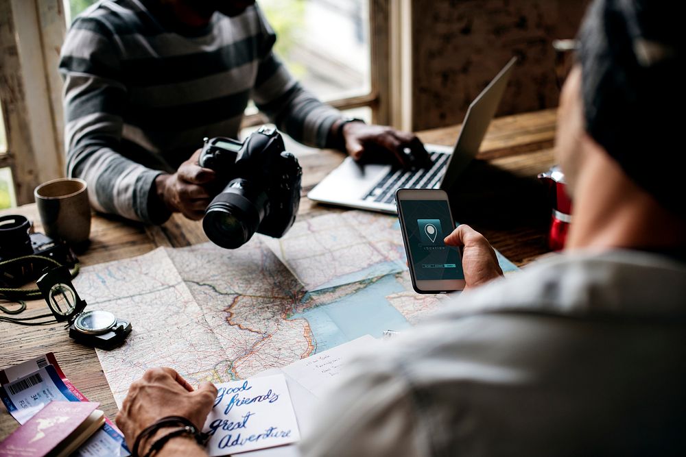 Men planning the journey with map and gps