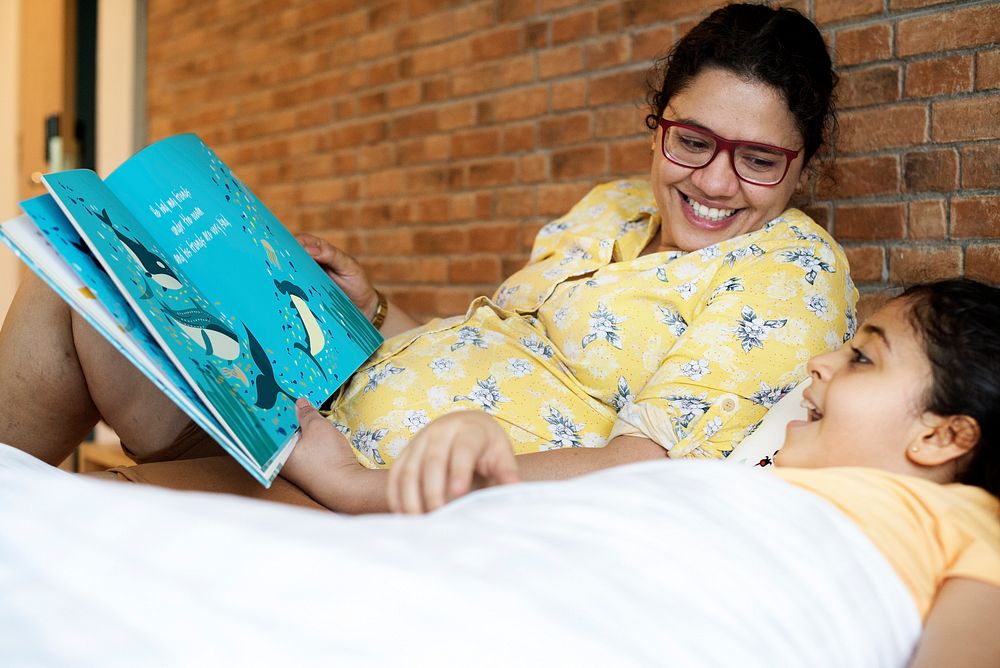 Mom and daughter reads story book