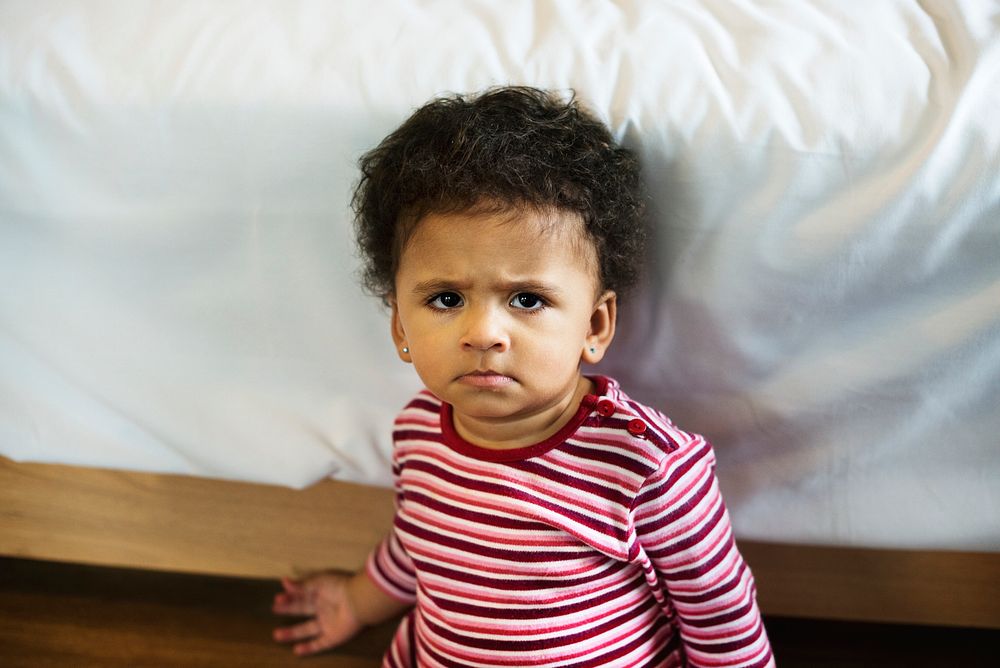 Little toddler girl with a serious look on her face