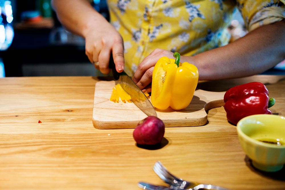 Hands cutting and preparing to cook