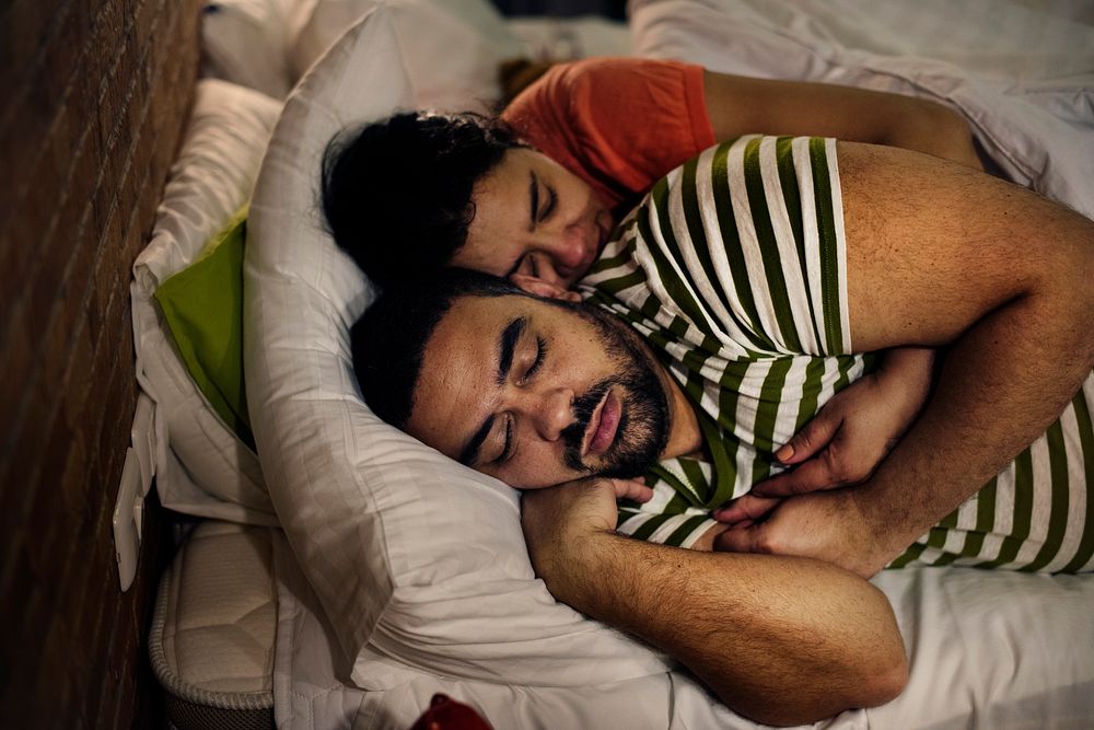 Couple sleeping together in the bed