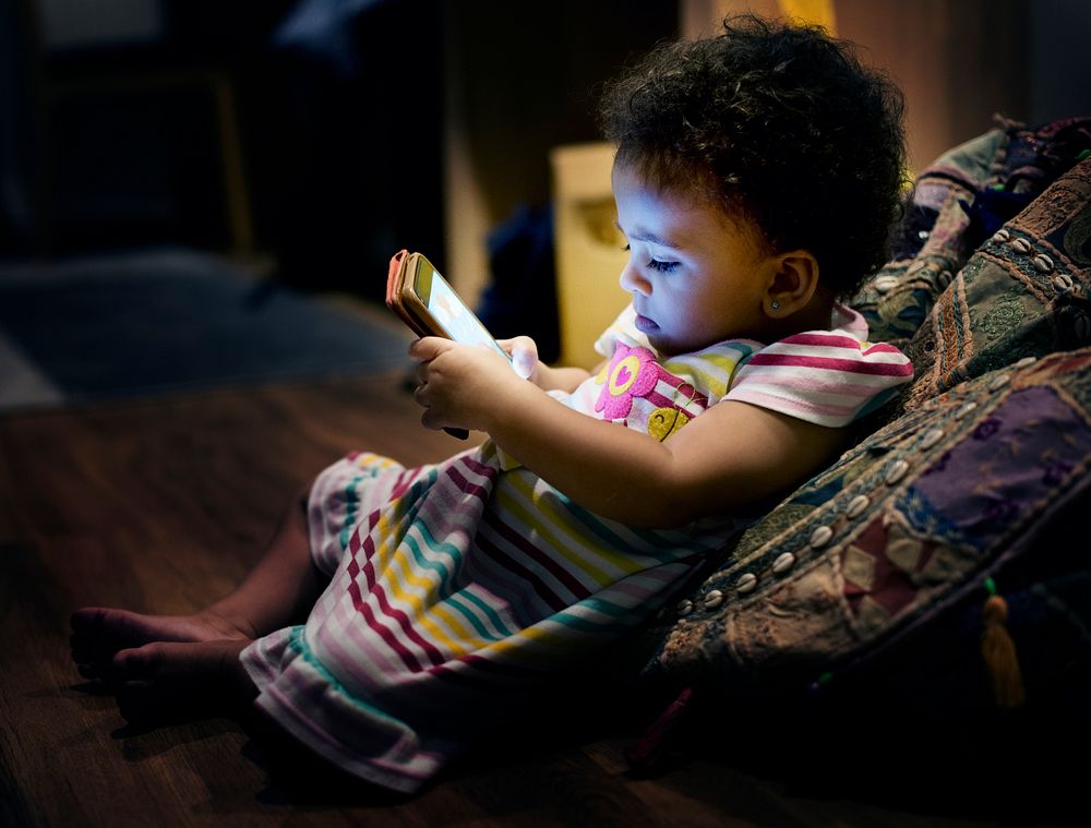 Little toddler girl using mobile phone
