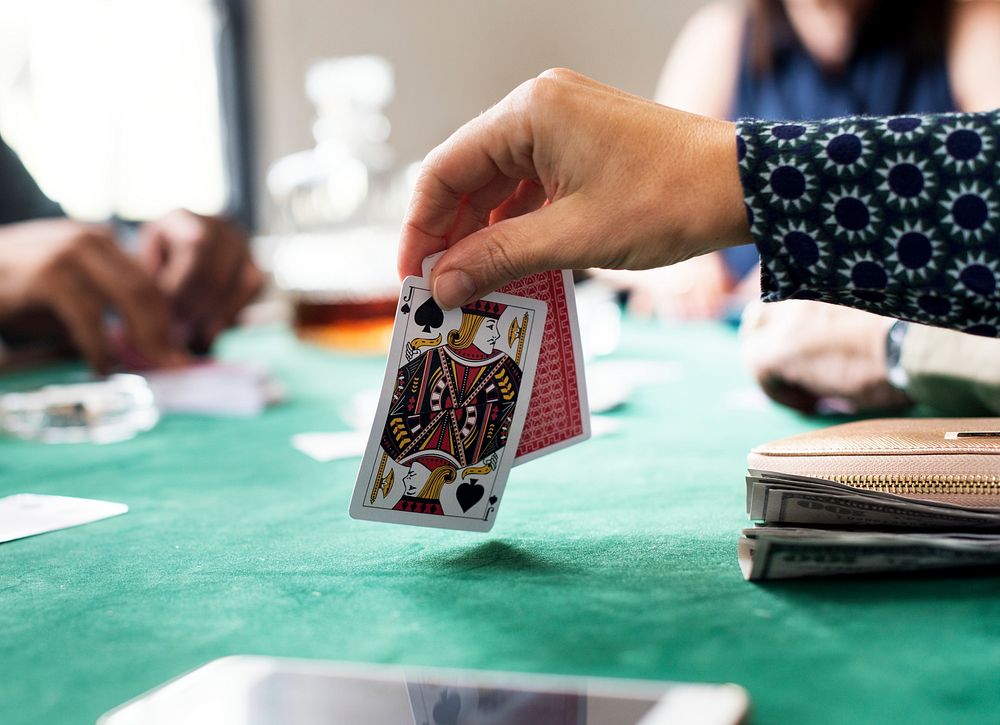 Adults socialising and playing cards 