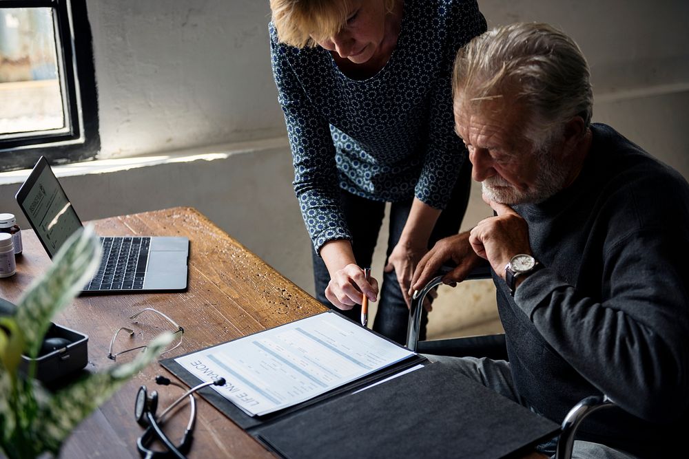 Elderly couple completing a form 