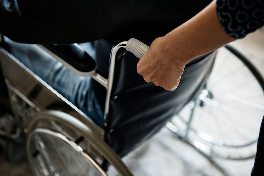 Closeup of a hand on wheelchair handle