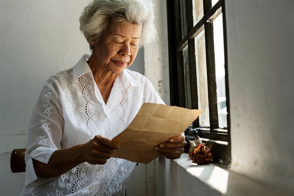 Elderly woman reading a letter 