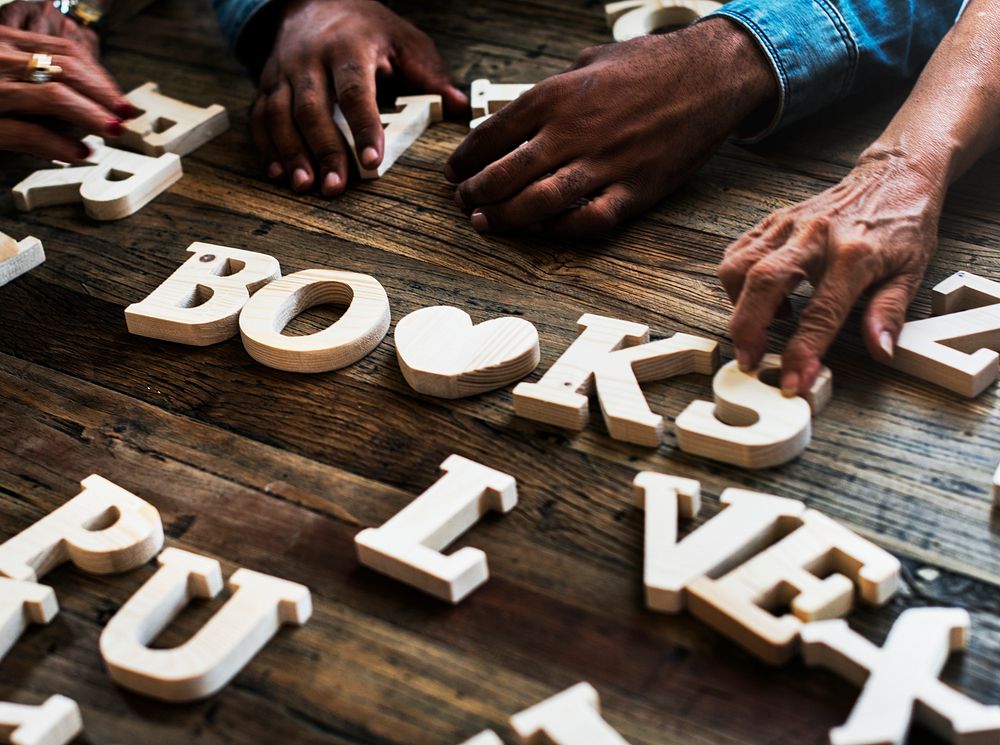 Diverse hands spell out books 