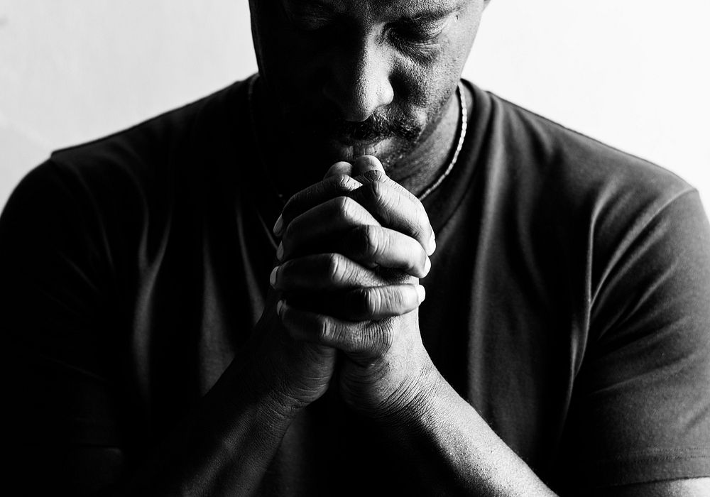 African American man resting his chin on his hands 