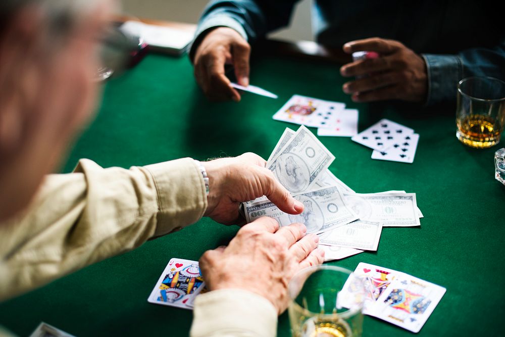 Adults socialising and playing cards 