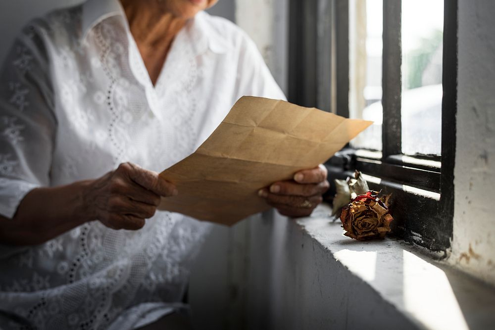 Elderly asian woman reading an old letter