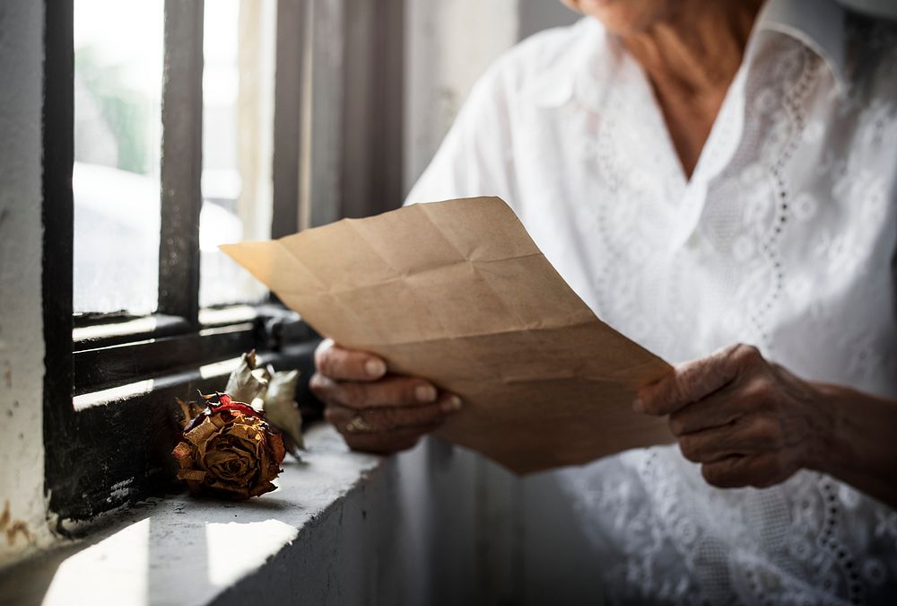 Elderly asian woman reading a letter 