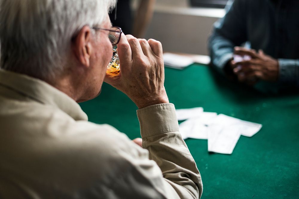 Adults socialising and playing cards 