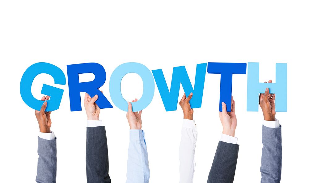 Group of Hands Holding the Word "GROWTH"