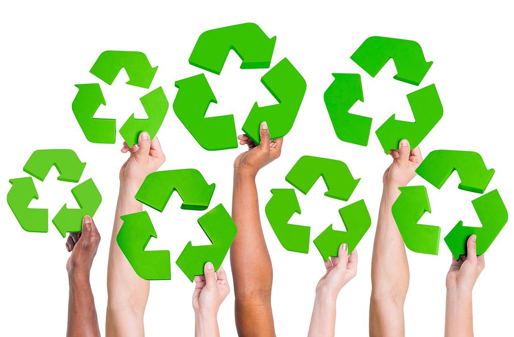 Multi-ethnic group of people holding recycling symbol.