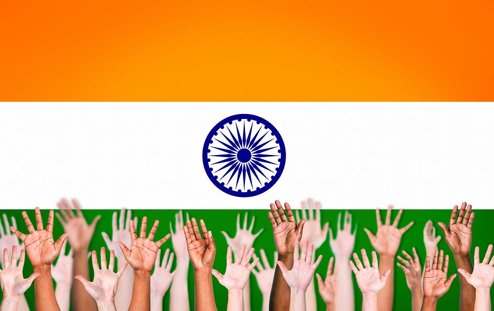 Group of Multi-Ethnic People's Hands Raised Up on an Indian Flag Background