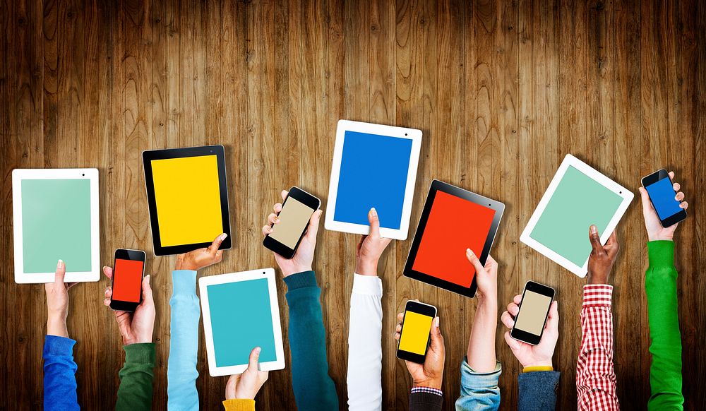 Group of Hands Holding Digital Devices with Copy Space