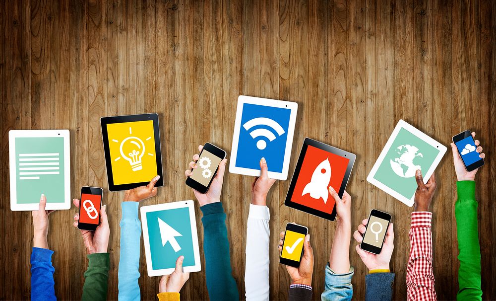 Group of Hands Holding Digital Devices with Symbols