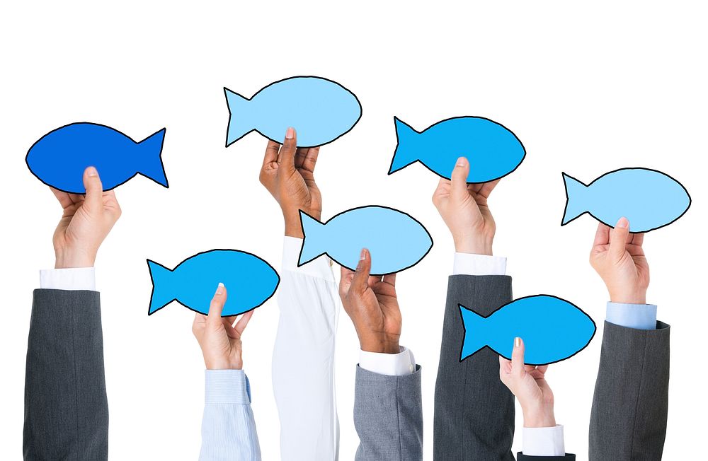 Business People Holding Fish Symbol and Contrasts Concept