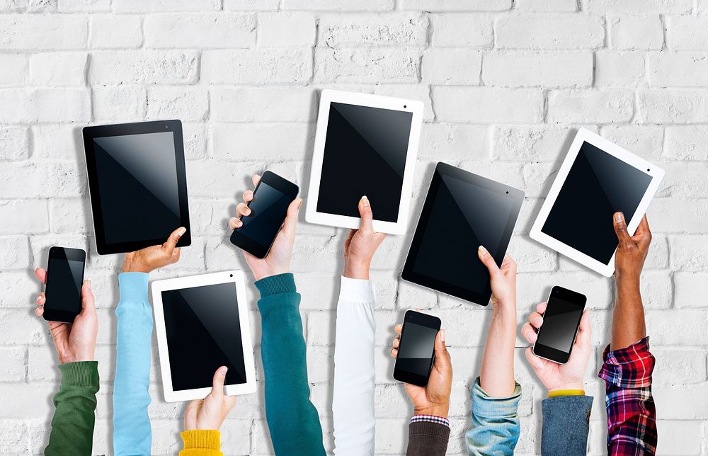 Group of Hands Holding Digital Devices