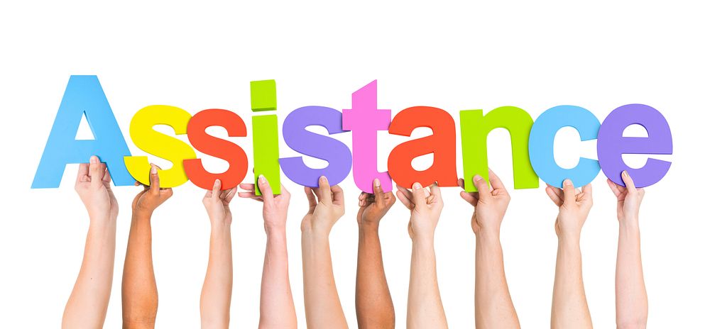 Multi-Ethnic Hands Holding Colorful Letters To Form Assistance