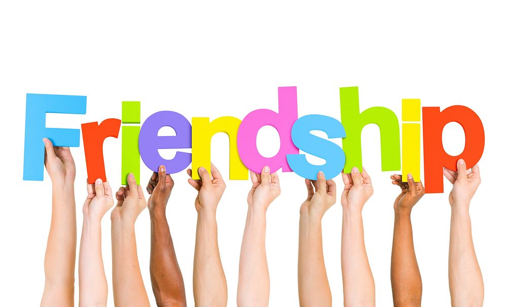 Multi Ethnic People Holding The Word Friendship