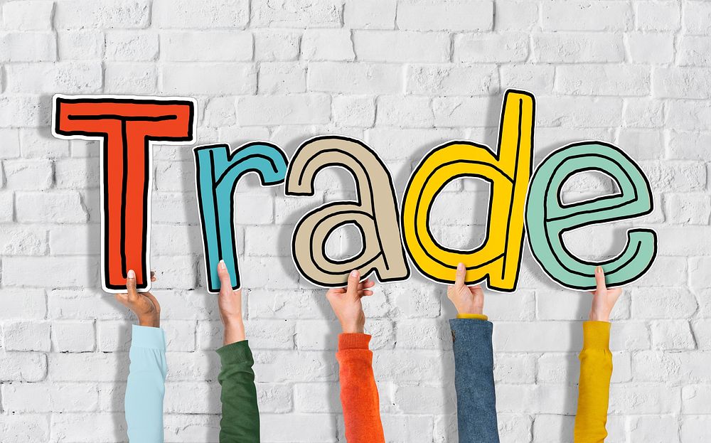Group of Hands Holding Letter Trade