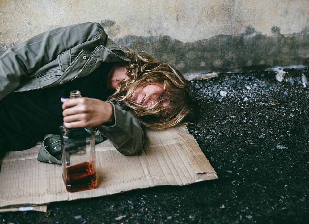 Drunk homeless man sleeping on the street