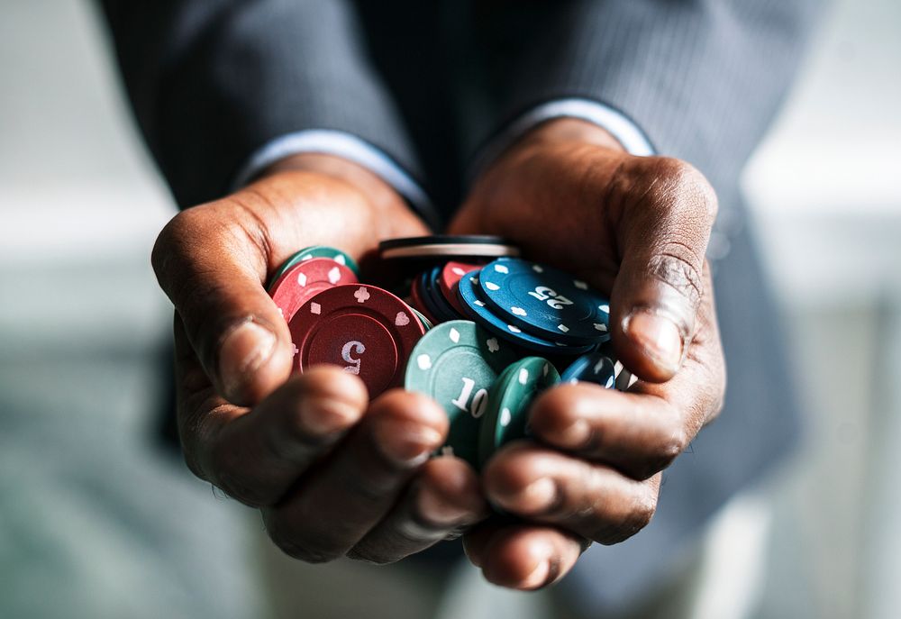 Man holding a handful of gambling chips