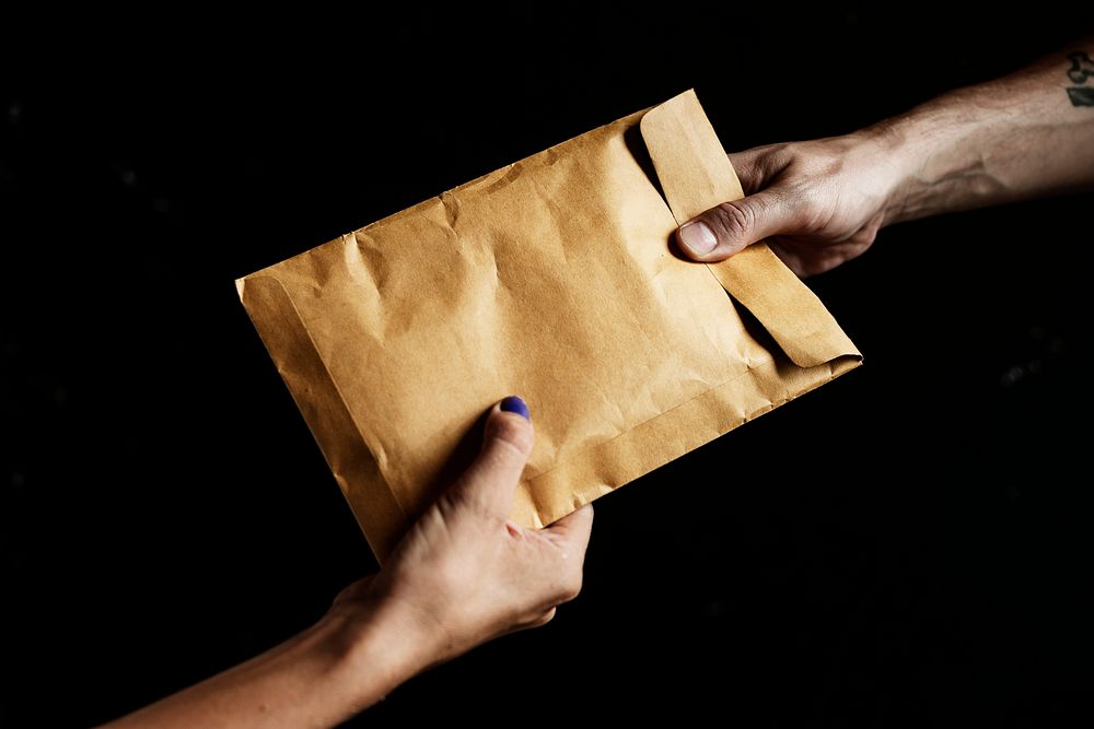 Handing out a brown envelope