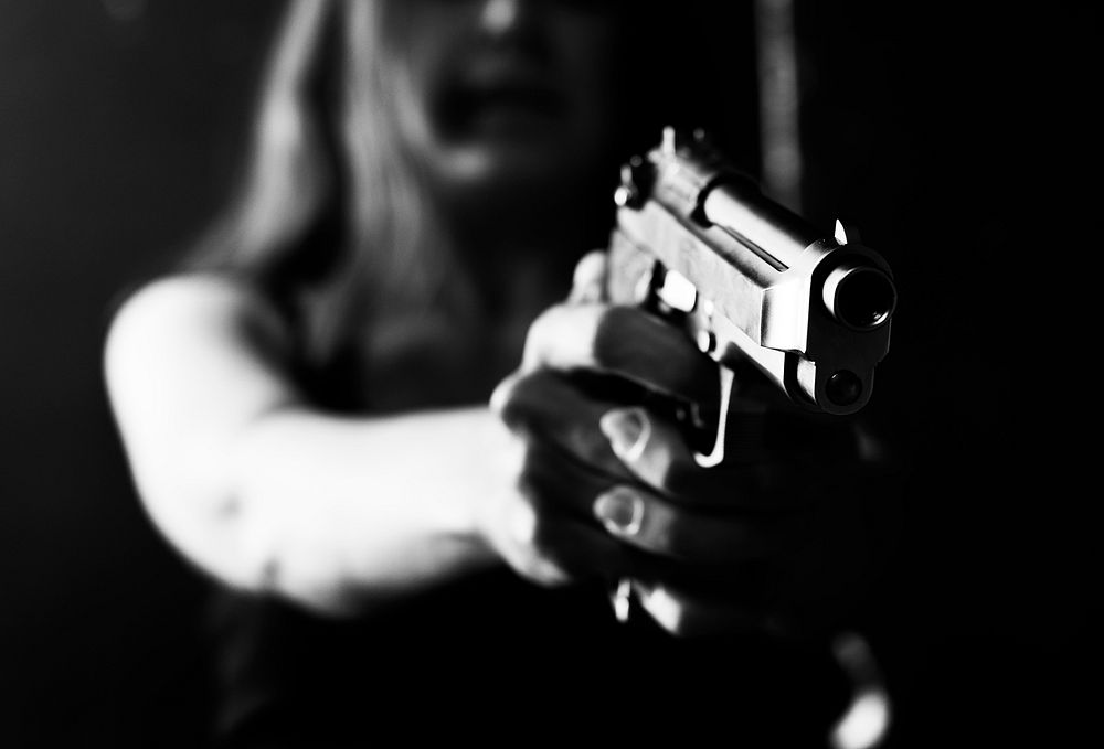 Woman pointing a gun