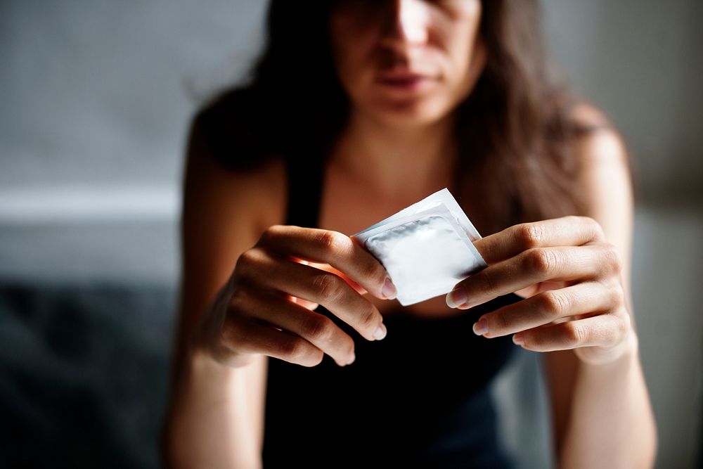 Woman holding a condom