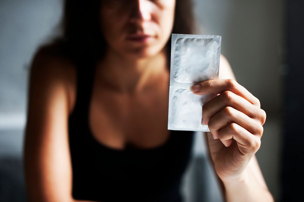 Woman holding condoms