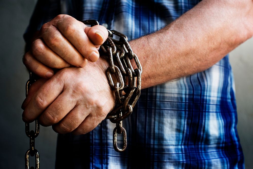 Man's hands chained up