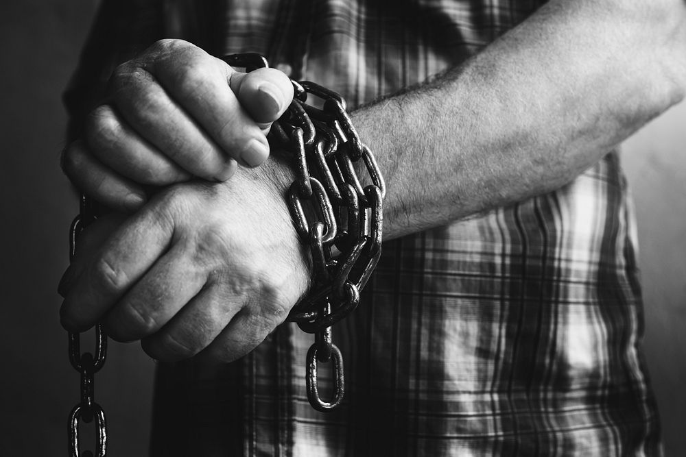 Man's hands chained up