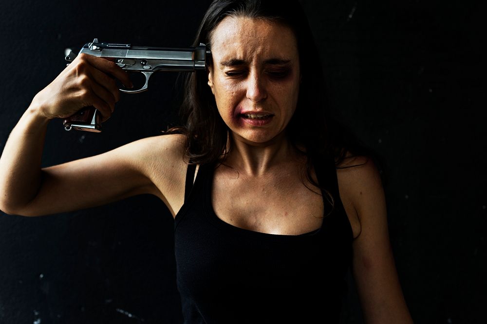 Suicidal woman holding a gun to her temple