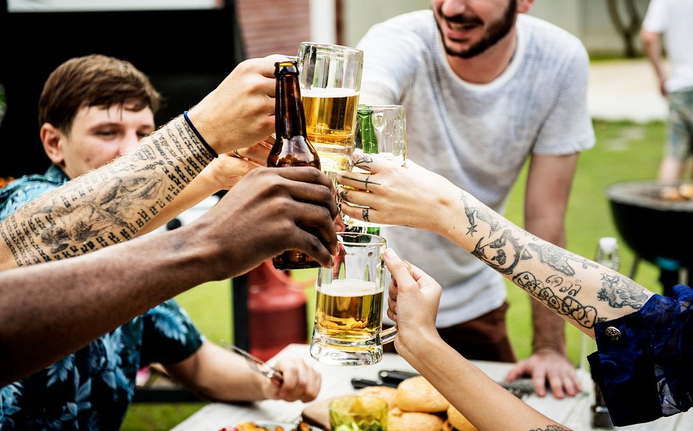 Group of diverse friends celebrating clinking beers together