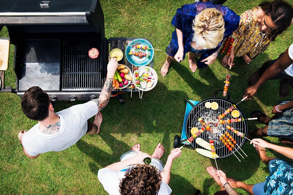 Aerial view of diverse friends grilling barbecue outdoors