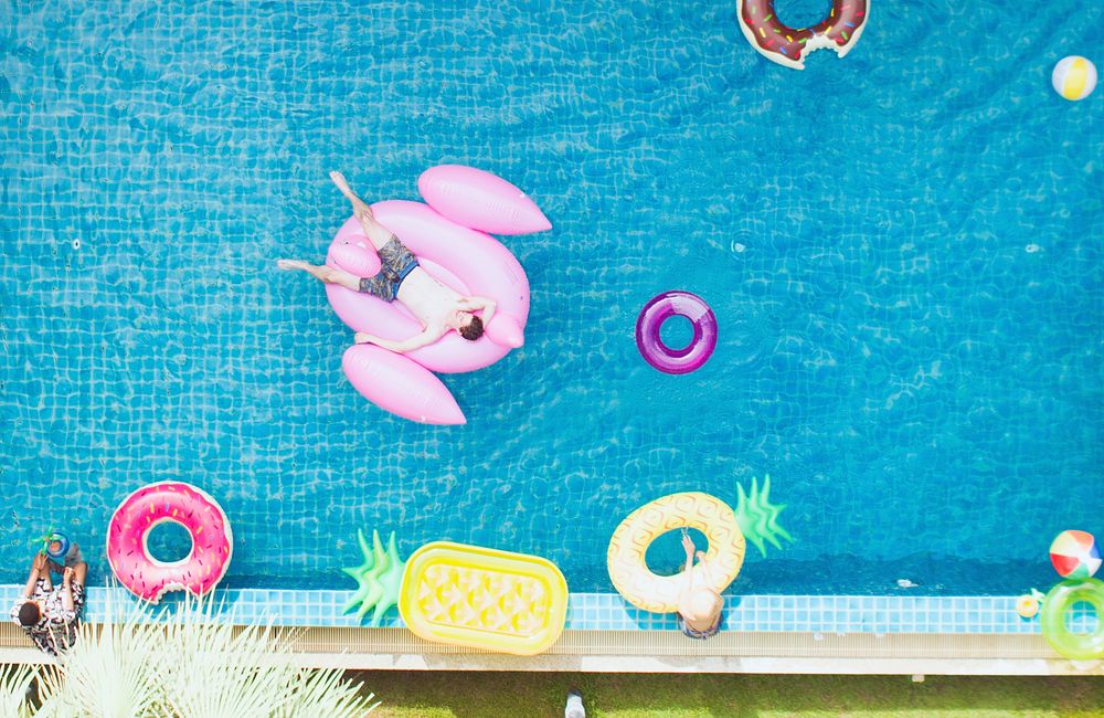 Aerial view of people enjoying the pool with inflatable tubes