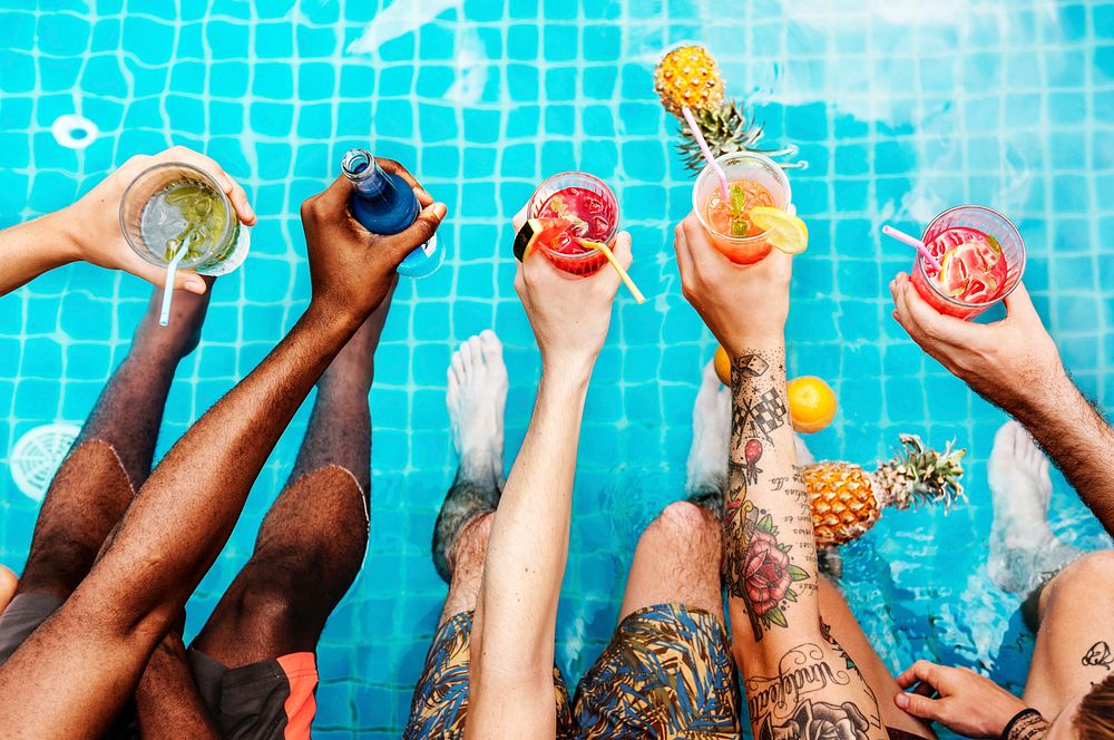 A diverse group of friends enjoying summer time with beverages in hands