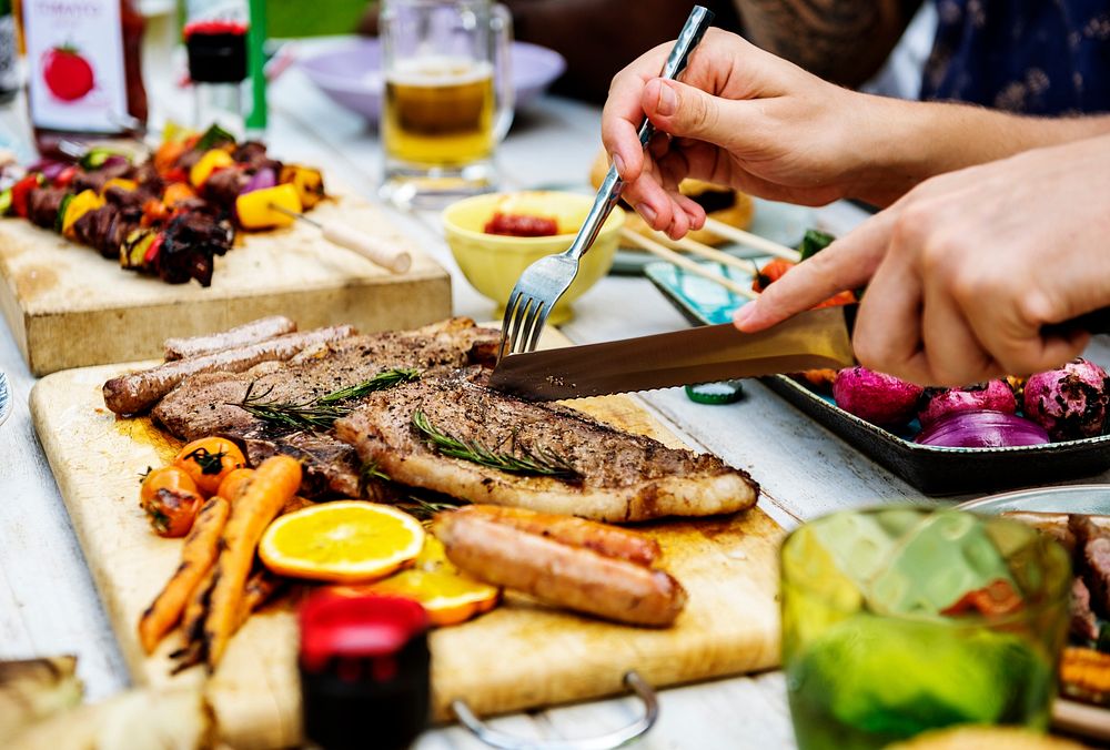 Closeup of homemade grilled food on wooden table summer party