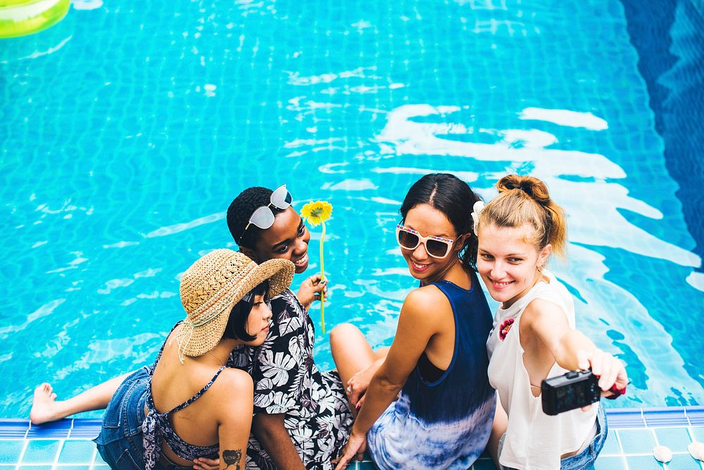 Group of diverse women taking selfie by the pool