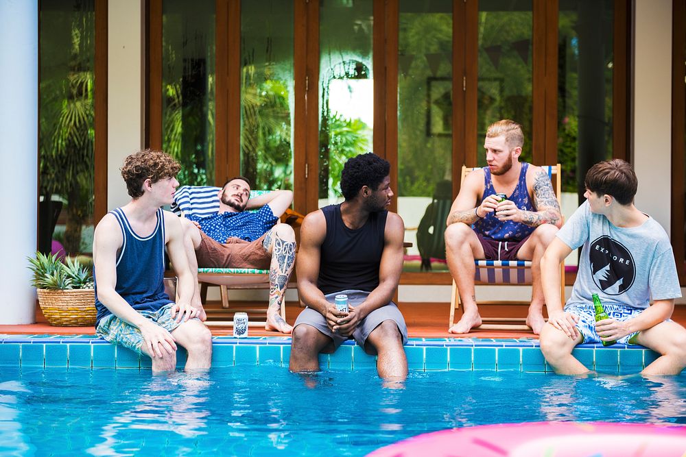 Group of diverse men sitting by the pool
