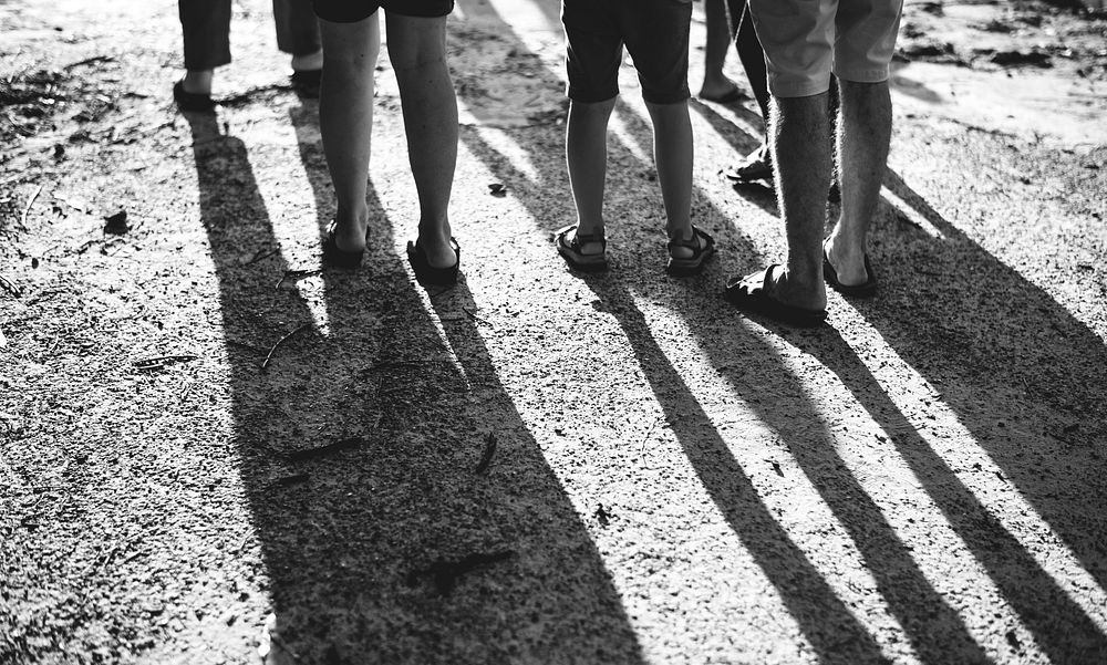 Group of people legs standing on the beach