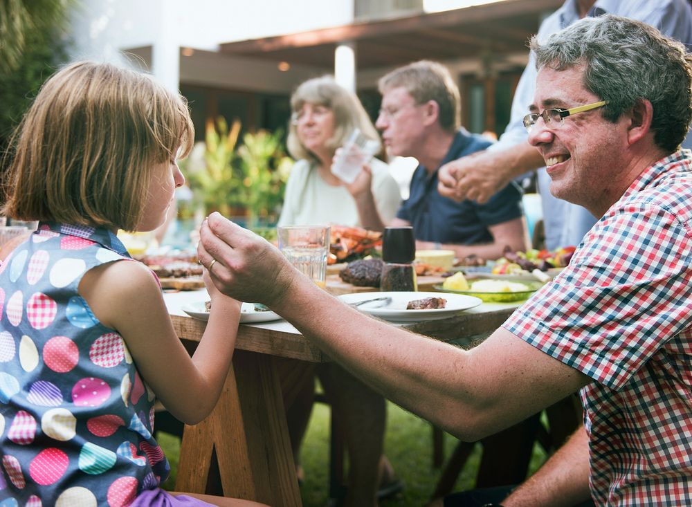 Group of people having BBQ party outdoors