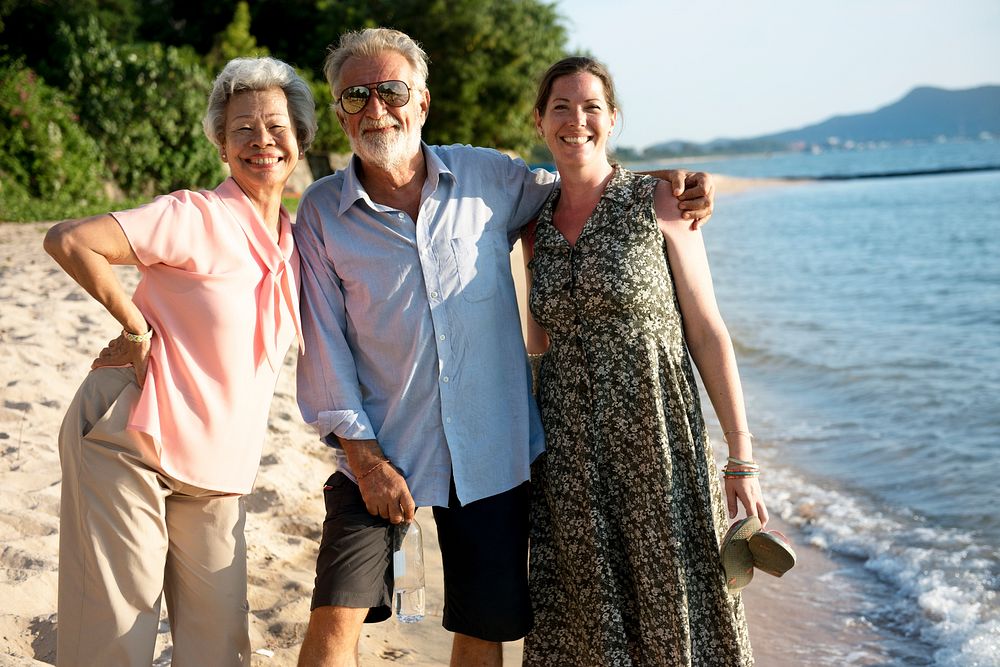 Diverse senior adult standing together at the beach
