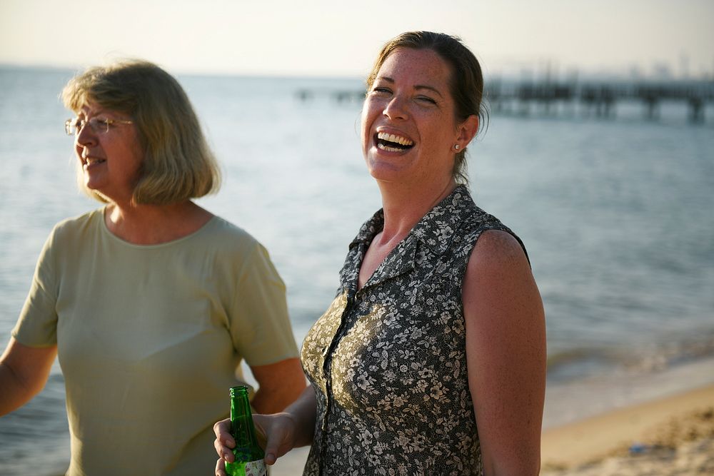 Two adult women ralaxing on a beach