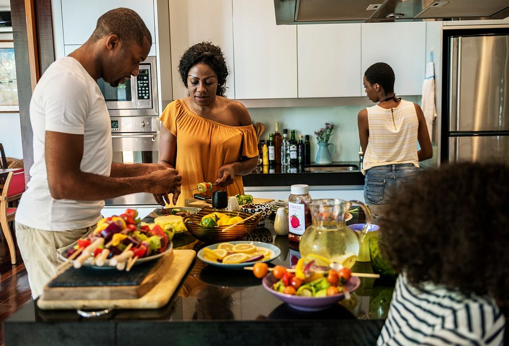 African family preparing barbecue in the kitchen together